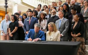 Rep. Steven Sainz watches Governor Kemp sign Miriam's Law